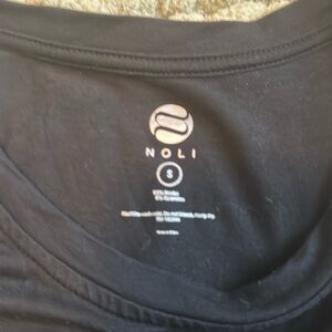 Noli Barre work out tank.  Black size small with the words “Tuck It”